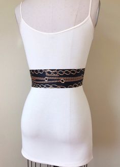 "Wide Black & Gold Chain Sash Belt Black and Gold Sash Gold Chain Link Belt Chain Link Sash Black and Gold Dress Sash Satin Swank Instantly update your jeans, dress, or top with this Satin Swank® black and gold chain print sash belt. Depending on your waist size and the length you choose (60, 75, and 90 inch lengths available), you can wrap this sash around your waist once or twice. You decide whether to tie the sash in a bow or a simple knot with long-hanging tails. Tie in front, in back, o Black Chain Belt For Night Out, Fitted Black Belts With Sashes, Black Fabric Belt For Summer, Black Chain Belt For Party, Black Party Belts For Summer, Black Belts For Summer Party, Chic Black Chain Belt For Party, Chic Black Adjustable Chain Belt, Black Chain Belt With Chain Strap For Evening