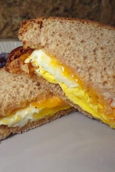 an egg and cheese sandwich with grapes on the side