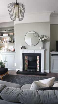 a living room filled with furniture and a fire place