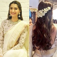 two women wearing white sari with flowers in their hair