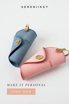 two pink and blue purses sitting next to each other on top of a white surface