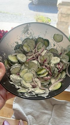 a bowl filled with sliced cucumbers and onions