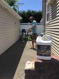 a man is washing his driveway with a pressure washer