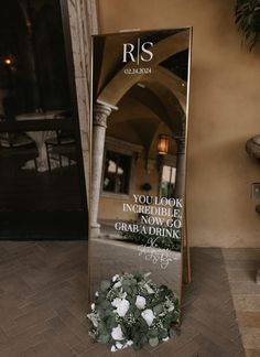 a large mirror sitting on top of a tiled floor