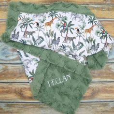 two baby bibs with personalized name and jungle animals on them, one is green and the other is white