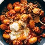 a blue bowl filled with food and a fork