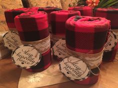 several red and black plaid fabric wrapped in twine on top of a wooden table