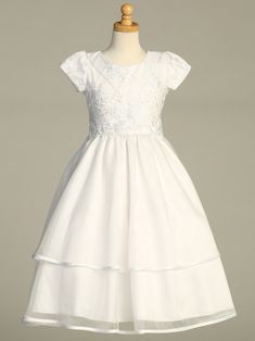 Girls White First Communion Dress w/ Embroidered Tulle & SequinsEmbroidered tulle dress w/ sequinsMade in U.S.A.Acetate Lining (soft)Zip Fastening with bow tieTea LengthDry Clean OnlyAccessories are sold separately- FREE domestic shipping.Inventory changes a lot during communion season (January-May) every effort is made to remove sizes/styles when they sell out. If the size/style you ordered is sold out, we will notify via email or message. Short Sleeve Organza Dress With Fitted Bodice, Short Sleeve Tulle Dress With Floral Applique, Fitted Embroidered Dress For First Communion, Embroidered Fitted Dress For First Communion, Short Sleeve Dress With Fitted Bodice For Confirmation, Short Sleeve Dress With Sequins And Fitted Bodice, Fitted Organza Dress For First Communion, Fitted Tulle First Communion Dress With Floral Applique, Fitted Lace Bodice Dress For Confirmation