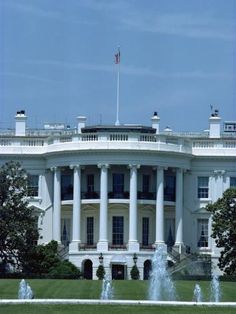 the white house with fountain in front of it