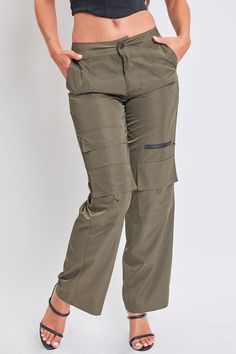 We’re obsessed with our new Women’s High Rise Nylon Cargo Pants, and we think you will be too. This high waisted parachute-inspired pant is constructed with lightweight polyester for a nice airy feel and features a straight-leg, relaxed fit that you'll want to wear all the time. Detailed with two functional cargo pockets at the knee, one faux cargo pocket at the thigh, and one decorative zipper for that added edge. Pair with a baby tank and tennies for a cool-casual look, or with a corset top an Stretch Nylon Wide-leg Parachute Pants, Trendy Straight Leg Pants For Outdoor, High-waist Utility Parachute Pants For Outdoor, High Waist Utility Parachute Pants For Outdoor, High Waist Parachute Pants With Multiple Pockets For Outdoor, Utility High Waist Parachute Pants For Outdoor, Khaki High-waisted Utility Parachute Pants, High Waist Spring Cargo Pants For Outdoor, High Waist Parachute Pants With Cargo Pockets For Outdoor