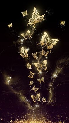 gold butterflies are flying in the air with sparkles on them, and there is no image to describe