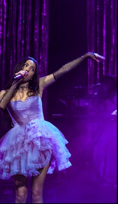 a woman in a white dress on stage