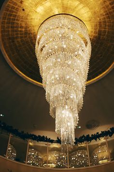 a large chandelier hanging from the ceiling in a room with lights on it