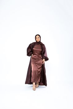 The Organza Abaya is statement outfit for any event. It's super lightweight yet so simple with the prettiest sheen. Complete the look with our matching long sleeve satin slip dress and a pair of strappy heels for a luxe finish or make it into a more casual look. *Please note that the color displayed in the picture might be slightly different due to the color resolution and lighting. Fabric Description & Care: Balloon Sleeves with elastic cuff Double Lined Material: Silk/Organza Dry Clean for bes Elegant Satin Maxi Abaya, Elegant Silk Maxi Abaya, Elegant Satin Abaya For Party, Evening Satin Maxi Abaya, Evening Satin Maxi-length Abaya, Satin Evening Abaya For Eid, Eid Evening Satin Abaya, Elegant Long Sleeve Satin Abaya, Silk Long Abaya For Party