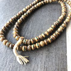 Unique and powerful Nepali Yak Bone Mala. Each bead has bras and small stone details. A unique unisex piece that will be perfect for your day by day outfits. The Mala is 40.6cm- 16 inch long A most have addition to your jewelry collection. Enjoy Con salud Spiritual Wooden Beads Jewelry For Meditation, Traditional 8mm Bead Jewelry For Festivals, Traditional 8mm Beaded Jewelry For Festivals, Wooden Beads Amulet Jewelry For Meditation, Meditation Amulet With Wooden Beads, Spiritual Wooden Beads Necklace For Meditation, Spiritual Wooden Beads Jewelry For Healing, Wooden Beads Amulet Necklace For Meditation, Meditation Amulet Necklace With Wooden Beads