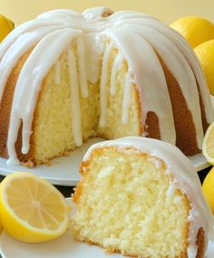 a lemon bunt cake with white icing and sliced lemons on the side