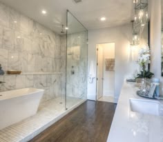 a large bathroom with marble walls and floors