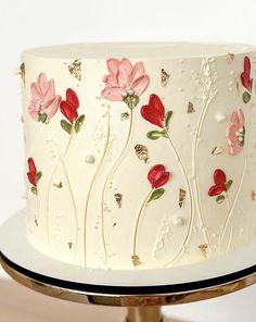 a white cake with red flowers on it