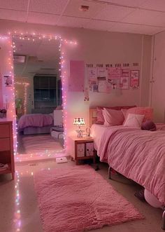 a bedroom with pink bedding and lights on the walls, carpeted flooring