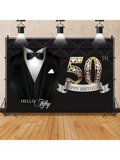 a 50th birthday backdrop with a tuxedo and bow tie