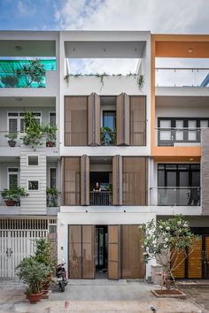 an apartment building with multiple balconies and wooden shutters