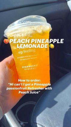 a person holding up a cup of lemonade in their hand with the caption peach pineapple lemonade