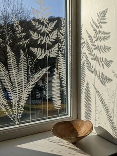 a wooden bowl sitting on top of a window sill