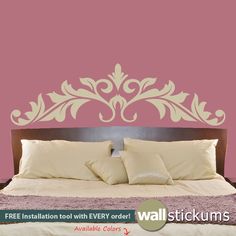 the wall sticker is designed to look like an ornate headboard on a bed