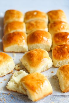 several pieces of bread sitting on top of a piece of wax paper next to each other