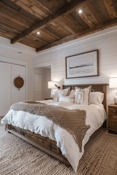 a large bed sitting under a wooden ceiling