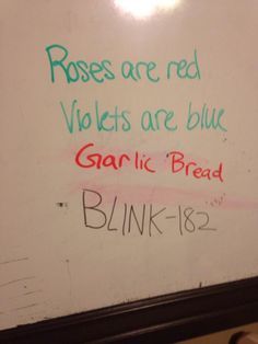 a white board with writing on it in a bathroom stall that reads roses are red violets are blue garlic bread blink - bye