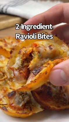 two ingredient ravioli bites are being held by a person's hand with the title, 2 ingredient ravioli bites