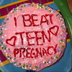 a birthday cake with the words i beat teen organic written on it and sprinkles