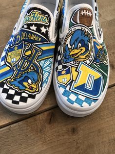 Custom, hand painted slip on Vans University of Delaware Blue Hens sneakers. Can be done in Converse with your school or logo! Contact me to create your custom pair! Blue Custom Artwork Sneakers, Artistic Blue Sneakers For Streetwear, Custom Hand Painted Blue Sneakers, Custom Blue Hand Painted Sneakers, Blue Custom Artwork High-top Sneakers, Blue High-top Sneakers With Custom Artwork, Blue Custom Artwork Sneakers With Round Toe, Artistic Blue Custom Sneakers With Waterproof Paint, Blue Custom Sneakers With Artwork And Round Toe