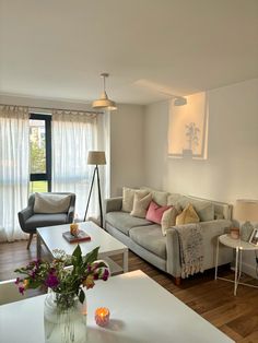 a living room filled with furniture next to a window