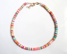 "more cute and fun necklaces and earrings in DearDanielleJewelry: https://www.etsy.com/shop/DearDanielleJewelry?ref=seller-platform-mcnav§ion_id=28417638 surfer heishi choker necklace. rainbow heishi beads necklace(necklace only). rubber beads necklace. cute surfer necklace. please choose your color: white, rainbow, pink, turquoise, black adjustable necklace length: 15-17\" Bead size: 1/4\" diameter **framed gems and charms are gold plated which means you can have beautiful and trendy jewelries Beach Fun Jewelry With Heishi Beads, Cute Rainbow Jewelry For The Beach, Cute Rainbow Jewelry For Beach, Colorful Heishi Beads Jewelry For The Beach, Colorful Heishi Bead Jewelry For Fun, Fun Colorful Heishi Beads Jewelry, Colorful Heishi Beads Jewelry, Fun Round Heishi Beads Jewelry, Heishi Beads Necklace