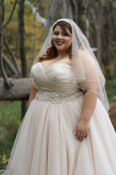 a woman in a wedding dress posing for the camera