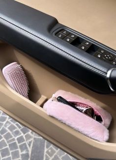 a hair dryer, comb and other items in a drawer