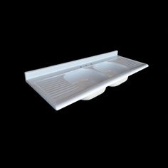 a white sink with two bowls on the bottom and one bowl in the middle, against a black background