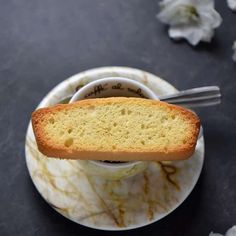 a piece of bread sitting on top of a saucer with a fork in it