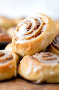 some cinnamon rolls are stacked on top of each other