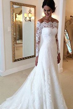 a woman in a white wedding dress posing for the camera with her hand on her hip