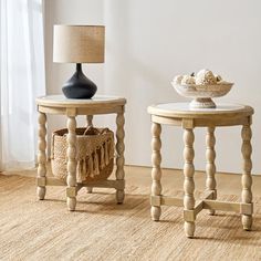 two wooden tables sitting next to each other on top of a carpeted floor in front of a window