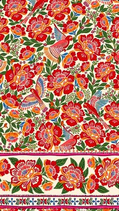 an intricately designed red and green floral design on white fabric with pink, blue, orange