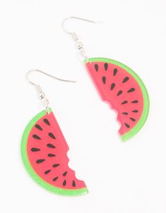 a pair of watermelon slices are hanging from earrings