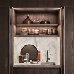 a kitchen with marble counter tops and wooden cabinets