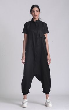 Black Linen Harem Jumpsuit - METJ0024 You asked for it, we made it happen especially for YOU! Behold our awesome drop-crotch linen jumpsuit! With a straight, free, and maxi silhouette, this overall is a top choice for your summer activities. It has a beautiful button front part with an accented collar. The length is 7/8 but you can also pull it up as shown in the pictures. We also put a statement front pocket for more comfort. Great for everyday wear, this plus-size jumpsuit is perfect for every Harem Jumpsuits, Womens Jumpsuits, Short Sleeve Jumpsuits, Linen Jumpsuit, Summer Linen, Black Tunic, Plus Size Jumpsuit, Plus Size Summer, Jumpsuit With Sleeves