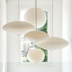 three white paper lanterns hanging from the ceiling