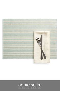 a fork and knife sitting on top of a place mat with the words annie selke