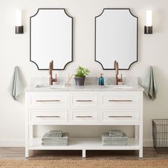 two mirrors are above the double sinks in this bathroom